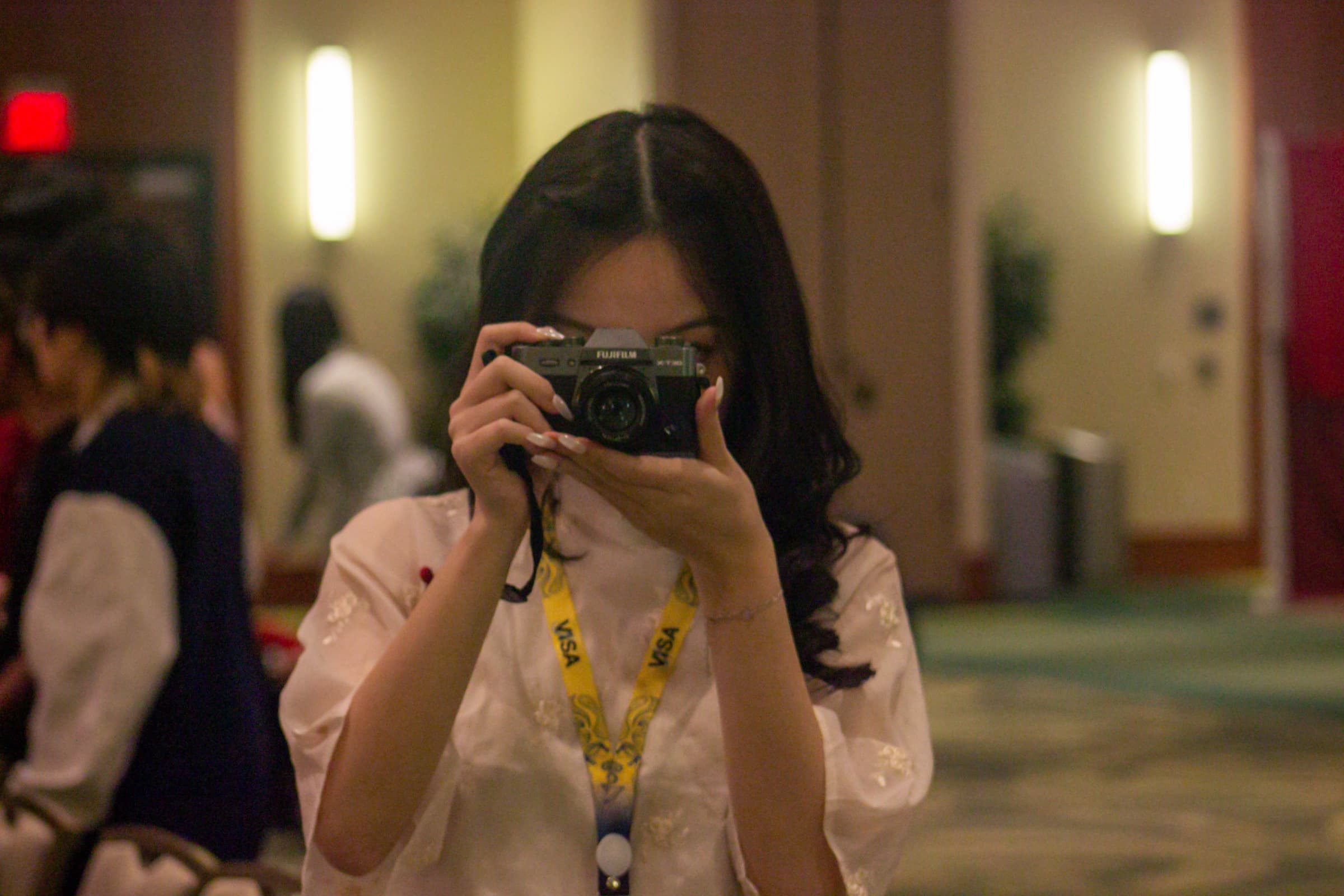 A VISA at USF member photographing a chapter event